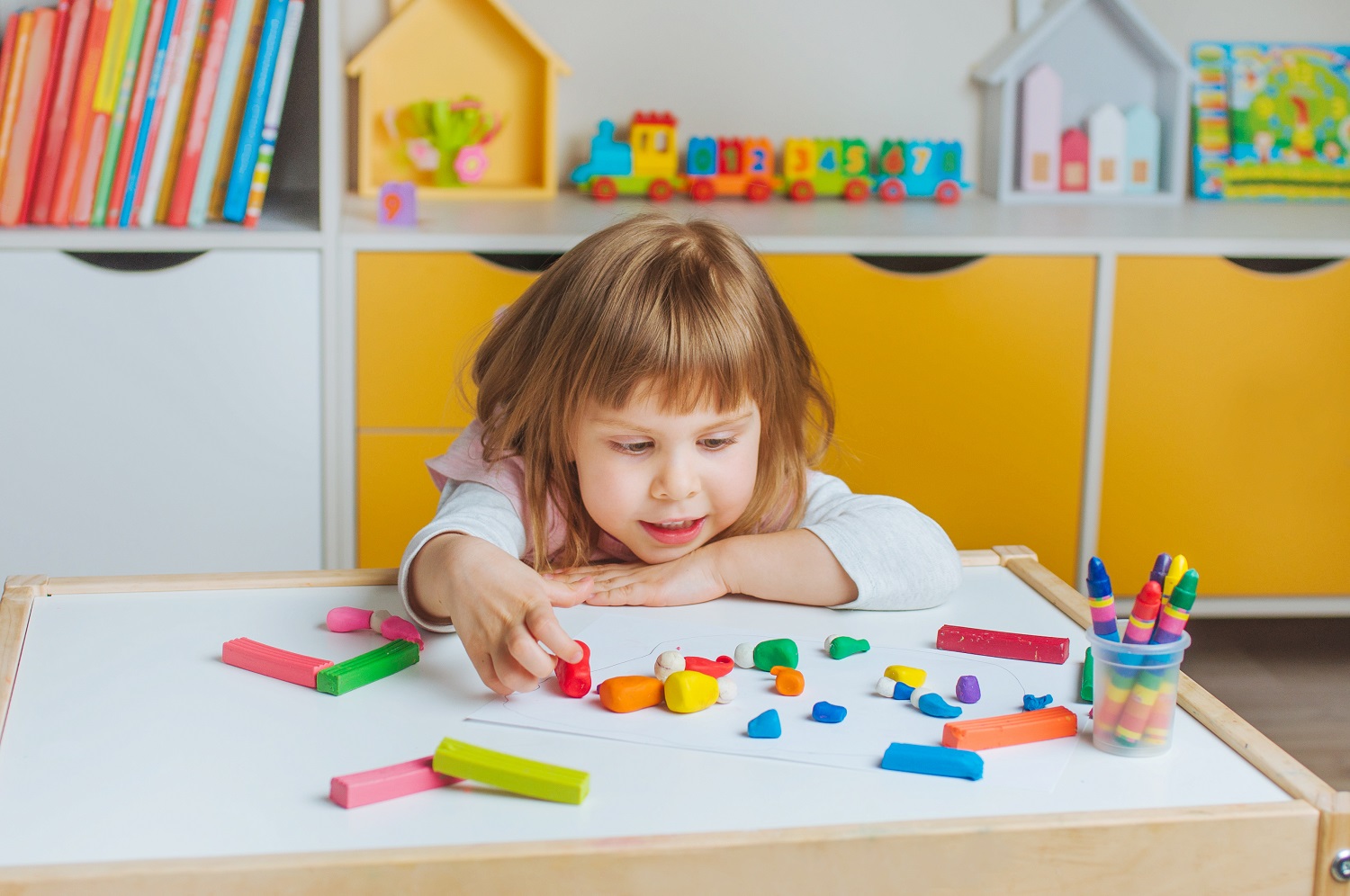 Little,Girl,Molding,From,Child's,Play,Clay,On,The,Table