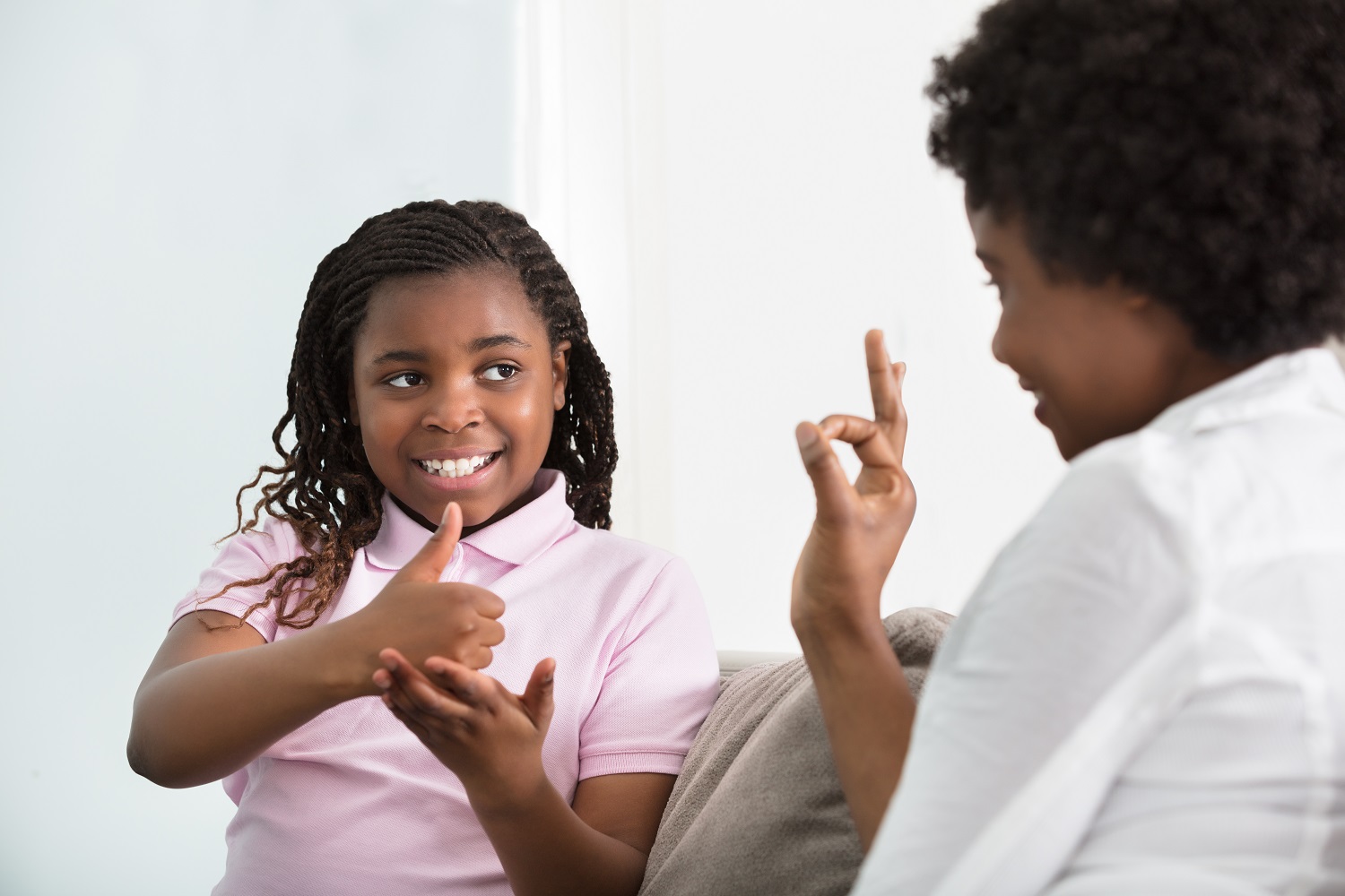 Smiling,Young,Mother,Learning,Sign,Language,To,Talk,With,Her